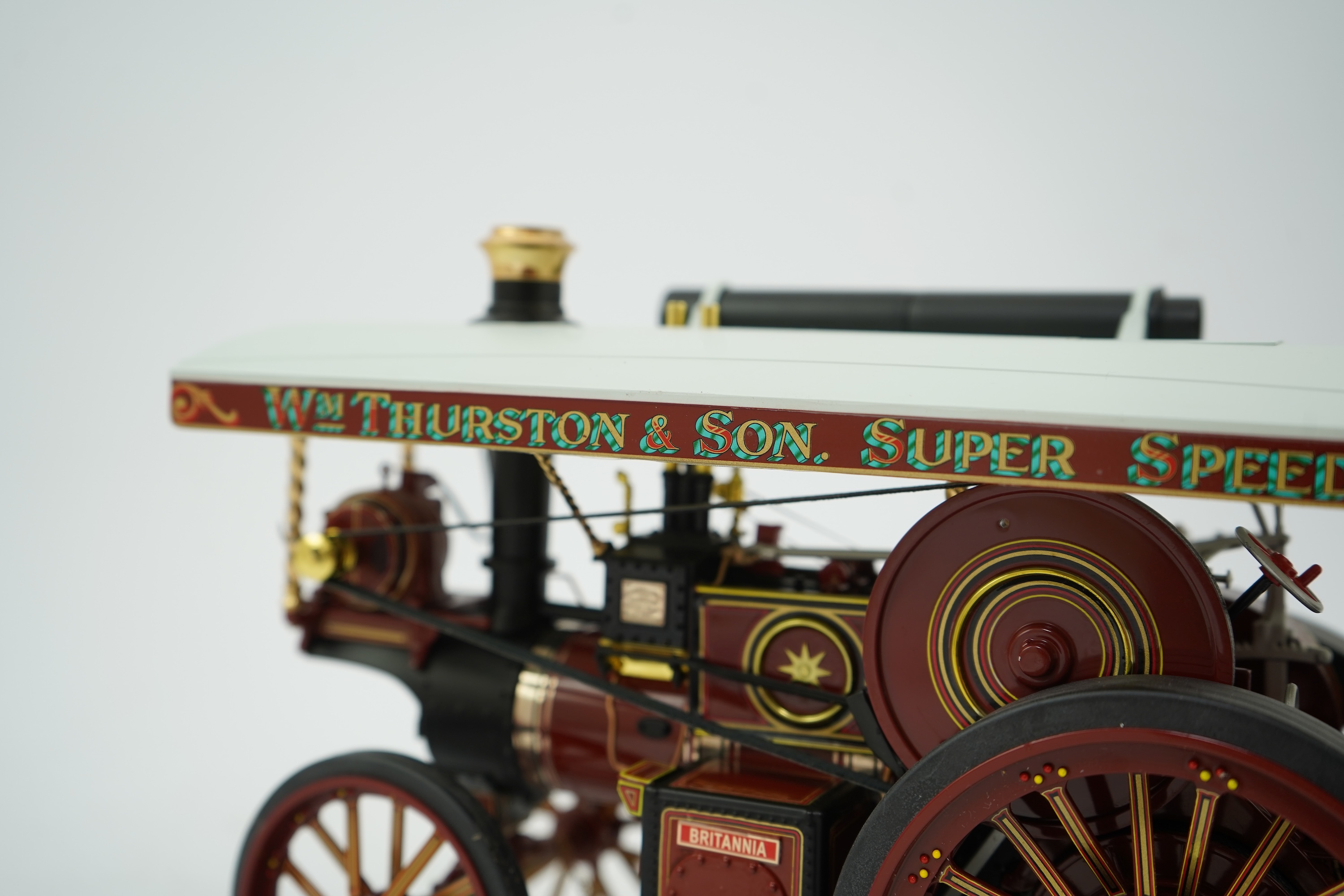 A Midsummer Models Ltd. 1:24 scale model of a Burrell Showman’s Engine, Britannia, in William Thurston and Son. Super Speed Cars livery, missing the original card box, but with an oak and Perspex display case